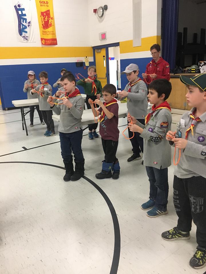 Scouts practising knots at a weekly meeting