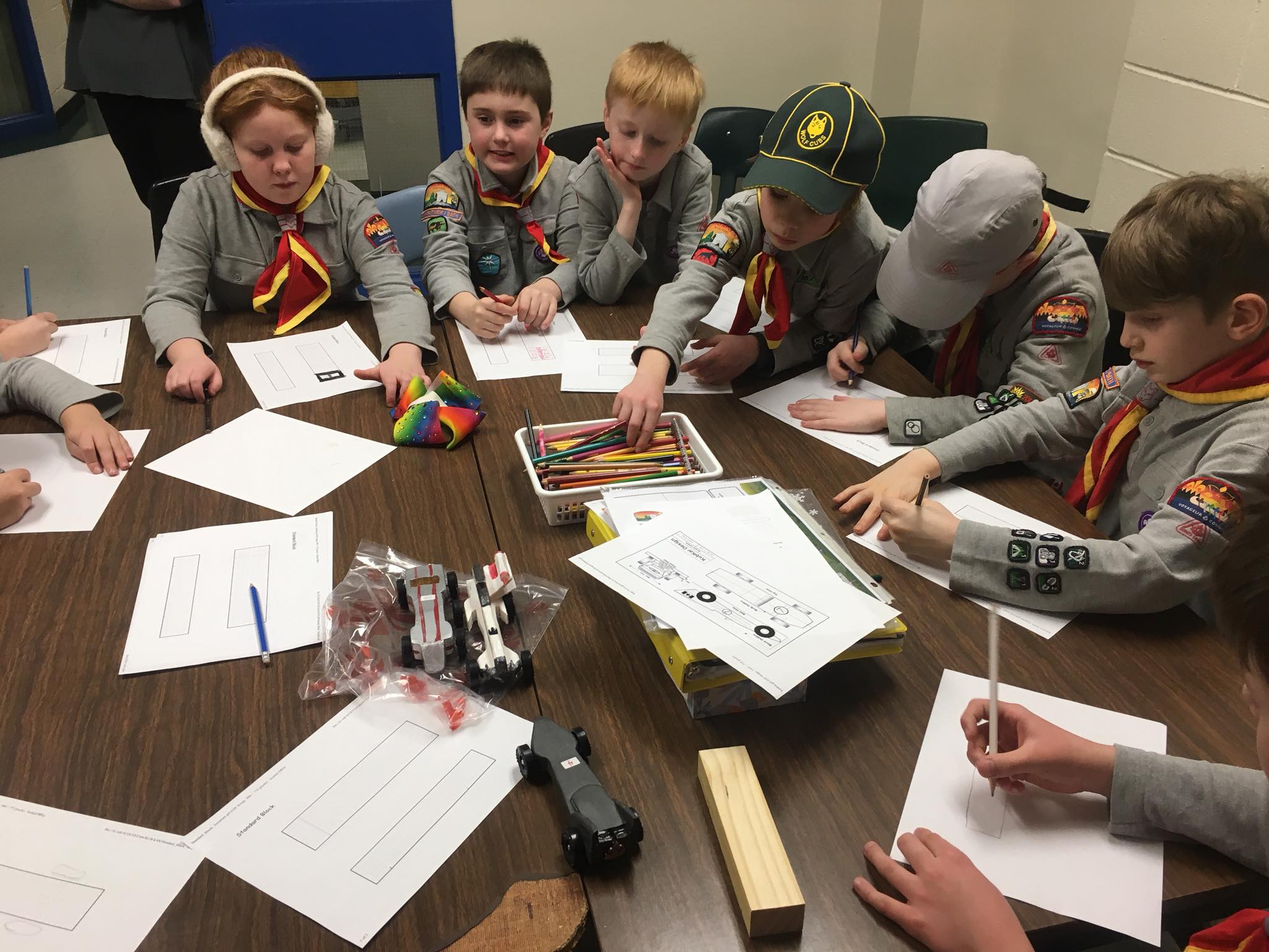 Scouts planning and drawing a construction project