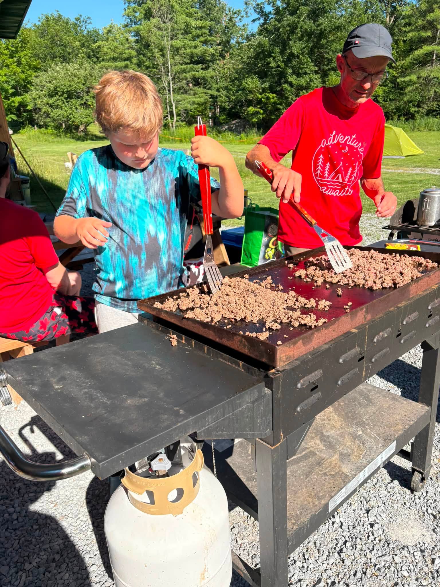 A Scout helping prepare food at camp